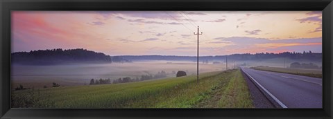 Framed Country road and telephone lines splitting farmlands at dawn, Finland Print