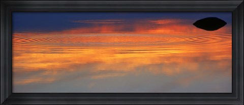 Framed Reflection of clouds with circular ripples spreading outward across glassy lake waters at sunset Print