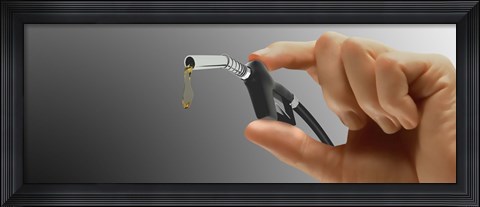 Framed Person's hand holding gas pump Print