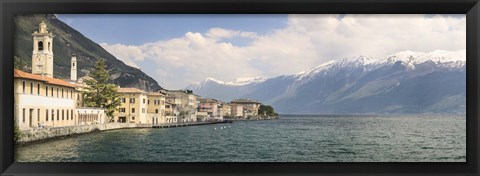 Framed Buildings at the waterfront with snowcapped mountain in the background, Gargnano, Monte Baldo, Lake Garda, Lombardy, Italy Print