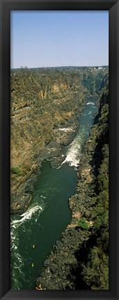 Framed Kayakers paddle down the Zambezi gorge away from the Victoria Falls, Zambia Print