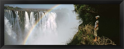 Framed Woman looking at a rainbow over the Victoria Falls, Zimbabwe Print