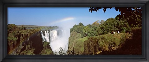 Framed Tourists at a viewing point looking at the rainbow formed over Victoria Falls, Zimbabwe Print