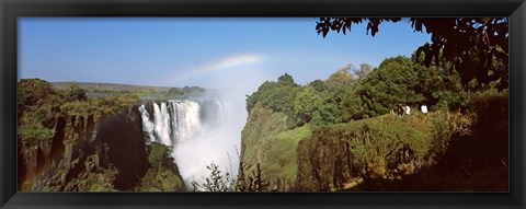 Framed Tourists at a viewing point looking at the rainbow formed over Victoria Falls, Zimbabwe Print