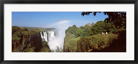 Framed Tourists at a viewing point looking at the rainbow formed over Victoria Falls, Zimbabwe Print