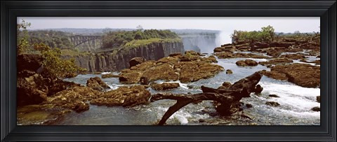 Framed Log on the rocks at the top of the Victoria Falls with Victoria Falls Bridge in the background, Zimbabwe Print