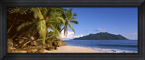 Framed Palm trees grow out over a small beach with Silhouette Island in the background, Seychelles Print