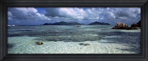 Framed Snorkeler in the clean waters on Anse Source d&#39;Argent beach, La Digue Island, Seychelles Print