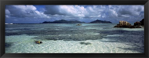 Framed Snorkeler in the clean waters on Anse Source d&#39;Argent beach, La Digue Island, Seychelles Print