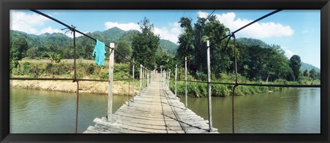 Framed Old wooden bridge across the river, Chiang Mai Province, Thailand Print