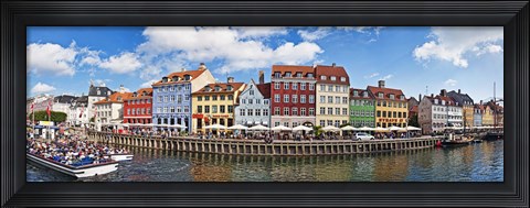 Framed Tourists in a tourboat with buildings along a canal, Nyhavn, Copenhagen, Denmark Print