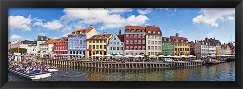 Framed Tourists in a tourboat with buildings along a canal, Nyhavn, Copenhagen, Denmark Print