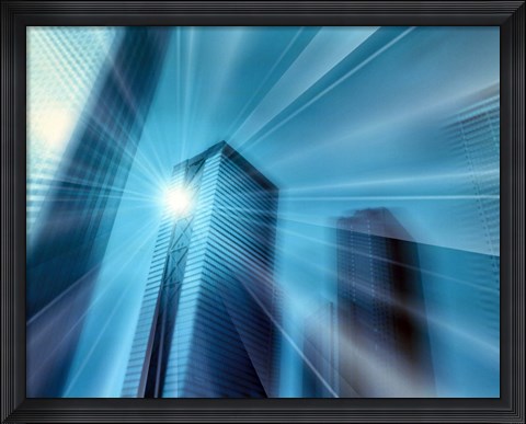 Framed Bright ball of light radiating rays of light in front of out of focus sky scrapers Print