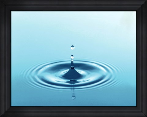 Framed Drops rising from ripples in blue water Print