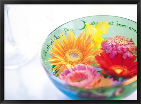 Framed Pink, orange and yellow flowers floating in a blue bowl Print