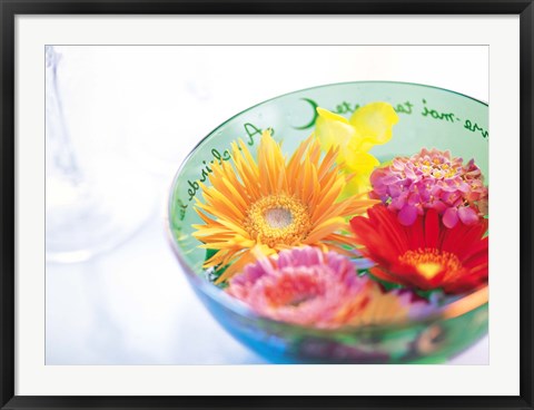 Framed Pink, orange and yellow flowers floating in a blue bowl Print