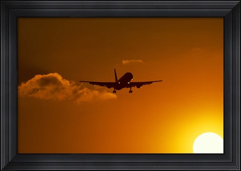 Framed Silhouette of airliner in golden sunset Print