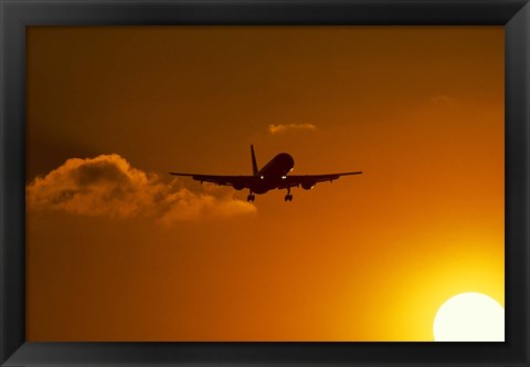 Framed Silhouette of airliner in golden sunset Print