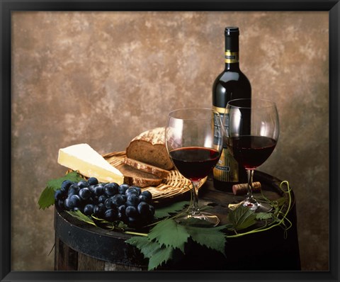 Framed Still life of wine bottle, wine glasses, cheese and purple grapes on top of barrel Print