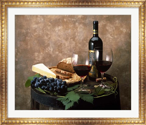 Framed Still life of wine bottle, wine glasses, cheese and purple grapes on top of barrel Print