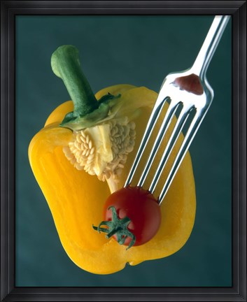 Framed Close up of half yellow pepper with cherry tomato in center on fork tines Print