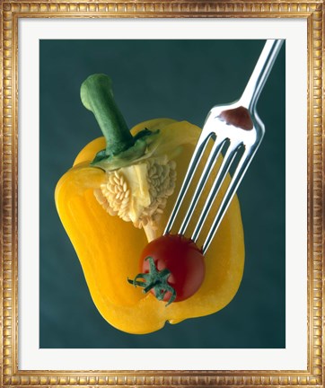 Framed Close up of half yellow pepper with cherry tomato in center on fork tines Print