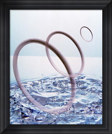 Framed Three opaque white circles floating away from churning water Print