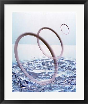 Framed Three opaque white circles floating away from churning water Print