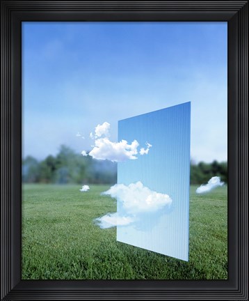 Framed White clouds passing through a pale blue horizontal of sky with green grass, trees and sky in the distance Print