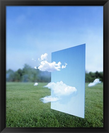 Framed White clouds passing through a pale blue horizontal of sky with green grass, trees and sky in the distance Print