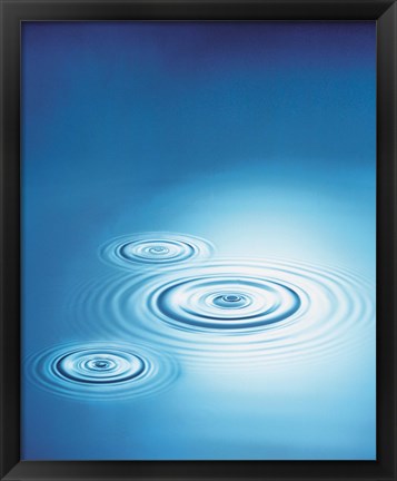 Framed Three rings in blue water with bright light reflection Print