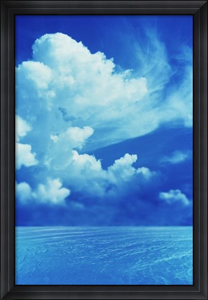 Framed White clouds in dark blue sky over rippling water Print