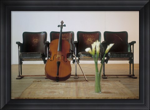 Framed Cello leaning on attached chairs Print