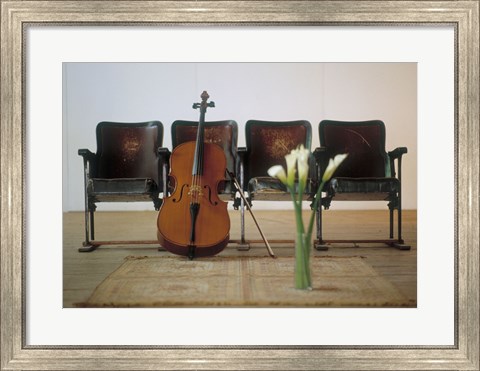 Framed Cello leaning on attached chairs Print