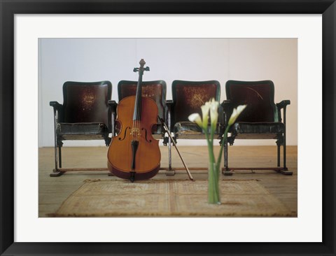 Framed Cello leaning on attached chairs Print