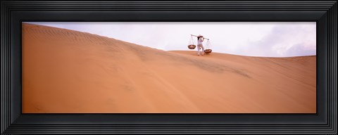 Framed Rear view of a woman carrying panniers, Mui Ne, Vietnam Print