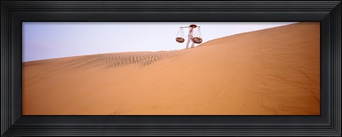 Framed Low angle view of a woman carrying panniers, Mui Ne, Vietnam Print