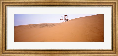 Framed Low angle view of a woman carrying panniers, Mui Ne, Vietnam Print