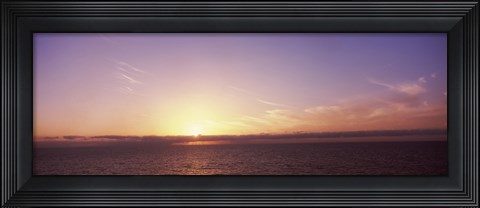 Framed Sun Setting Behind Clouds over the Sea Print