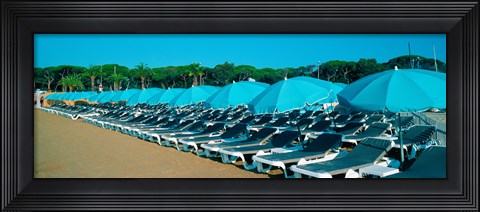 Framed Parasols with lounge chairs on a private beach in summer morning light, French Riviera, France Print