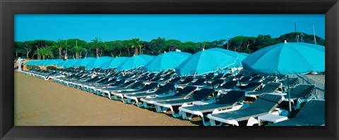 Framed Parasols with lounge chairs on a private beach in summer morning light, French Riviera, France Print