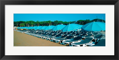 Framed Parasols with lounge chairs on a private beach in summer morning light, French Riviera, France Print