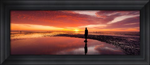 Framed Silhouette of human sculpture on the beach at sunset, Another Place, Crosby Beach, Merseyside, England Print