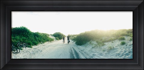 Framed Rear view of a couple cycling along a beach trail, Fort Tilden, Queens, New York City, New York State, USA Print