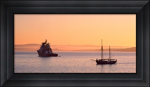 Framed Tugboat and a tall ship in the Baie de Douarnenez at sunrise, Finistere, Brittany, France Print