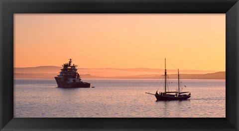 Framed Tugboat and a tall ship in the Baie de Douarnenez at sunrise, Finistere, Brittany, France Print