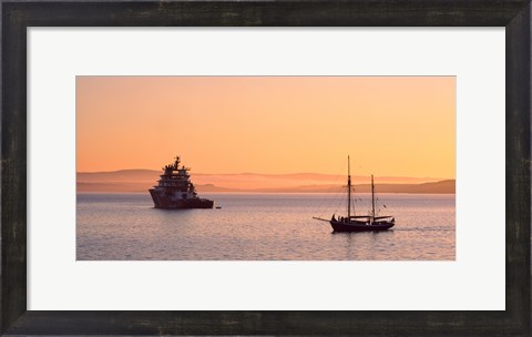 Framed Tugboat and a tall ship in the Baie de Douarnenez at sunrise, Finistere, Brittany, France Print