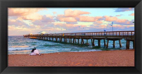 Framed Couple sitting on the beach at sunset, Fort Lauderdale, Florida, USA Print