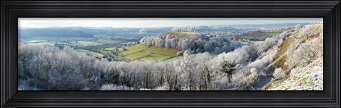Framed Snow covered trees in a valley from Uley Bury, Downham Hill, Gloucestershire, England Print