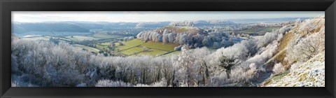 Framed Snow covered trees in a valley from Uley Bury, Downham Hill, Gloucestershire, England Print